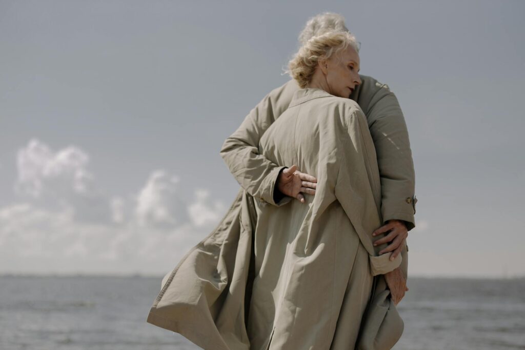 an elderly couple hugging each other